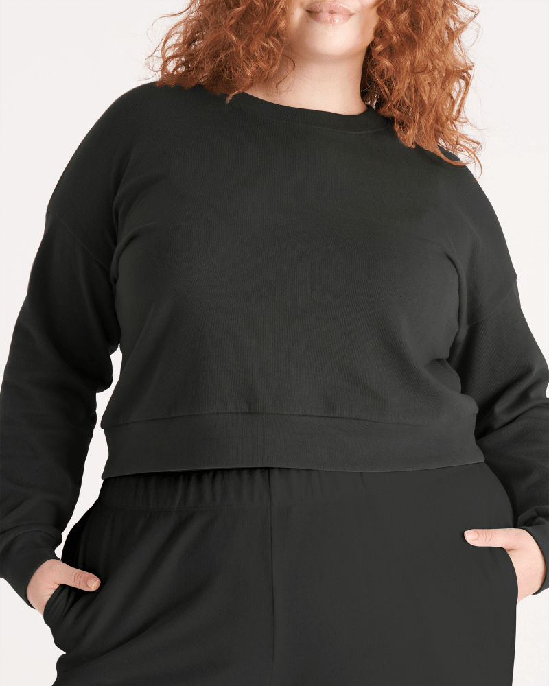Front of a model wearing a size 5X The Cropped Sweatshirt in Vintage Black by The Standard Stitch. | dia_product_style_image_id:248750